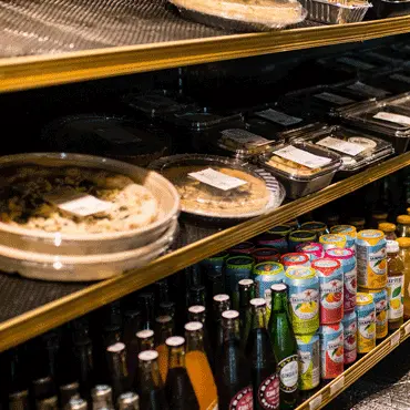 Prepared meals and bottled drinks in a refrigerated market display