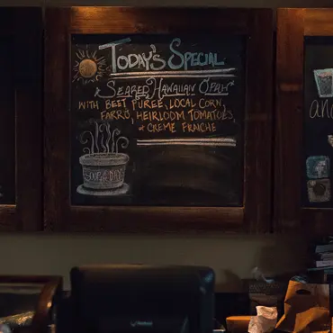 Chalkboard listing local producers at Market Tavern