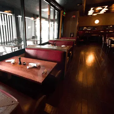 Red upholstered booths beside the restaurant windows