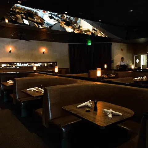 Dining booths beneath a long wall mural at Market Tavern Stockton