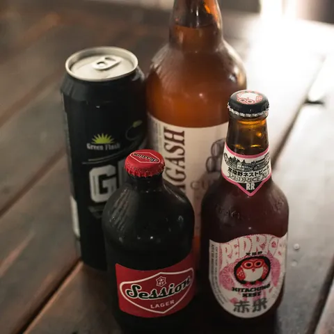 Bottled and canned beers on a wooden table
